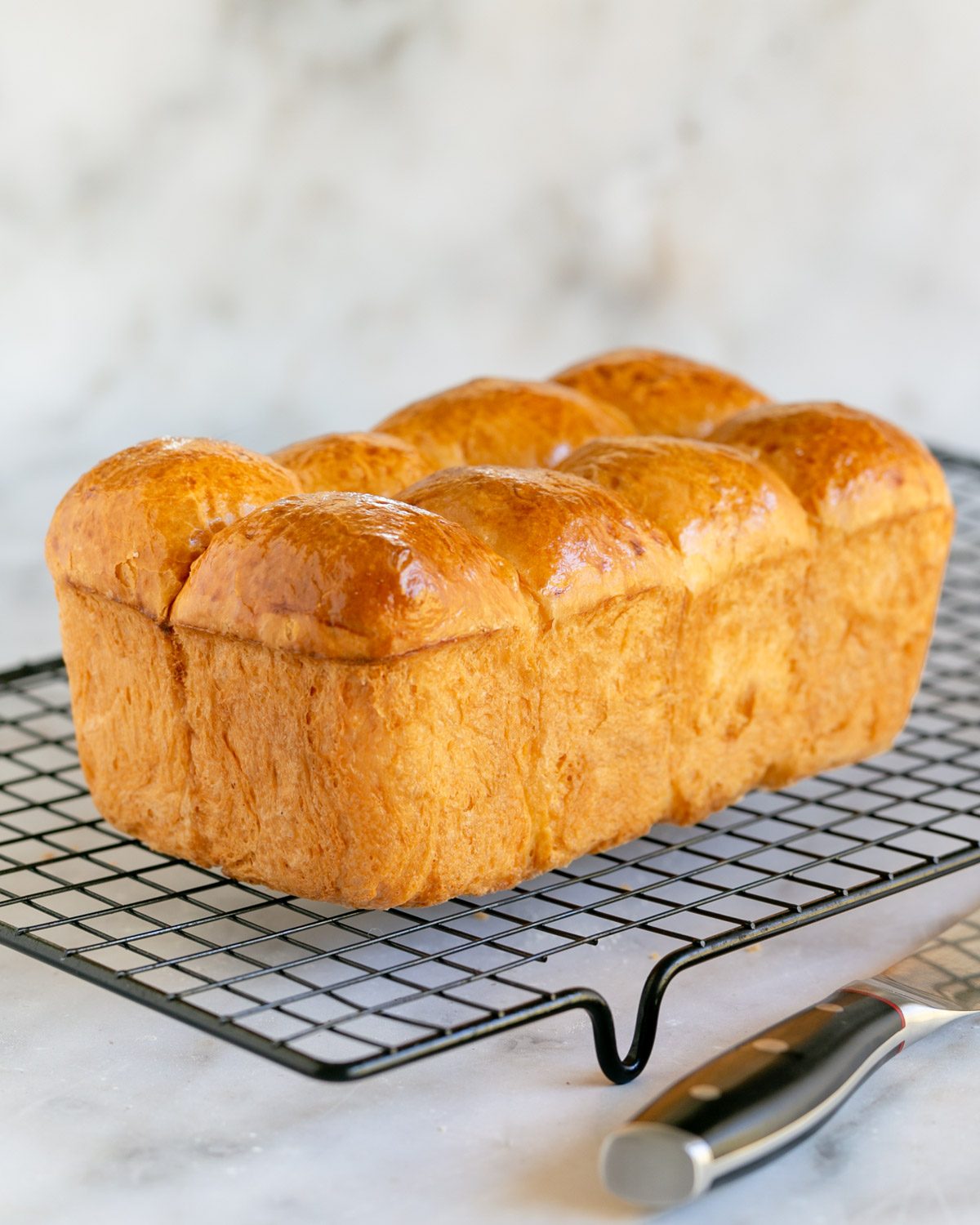 Brioche loaf on a cooling rack