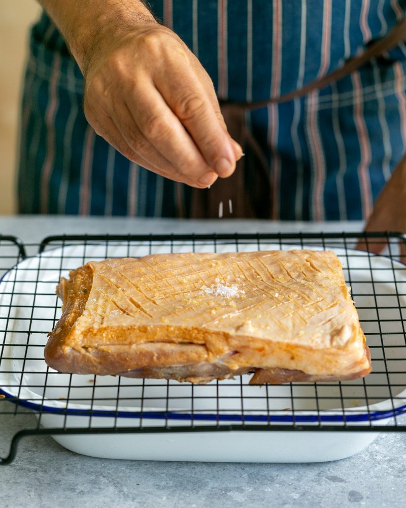 Seasoning pork belly before roasting