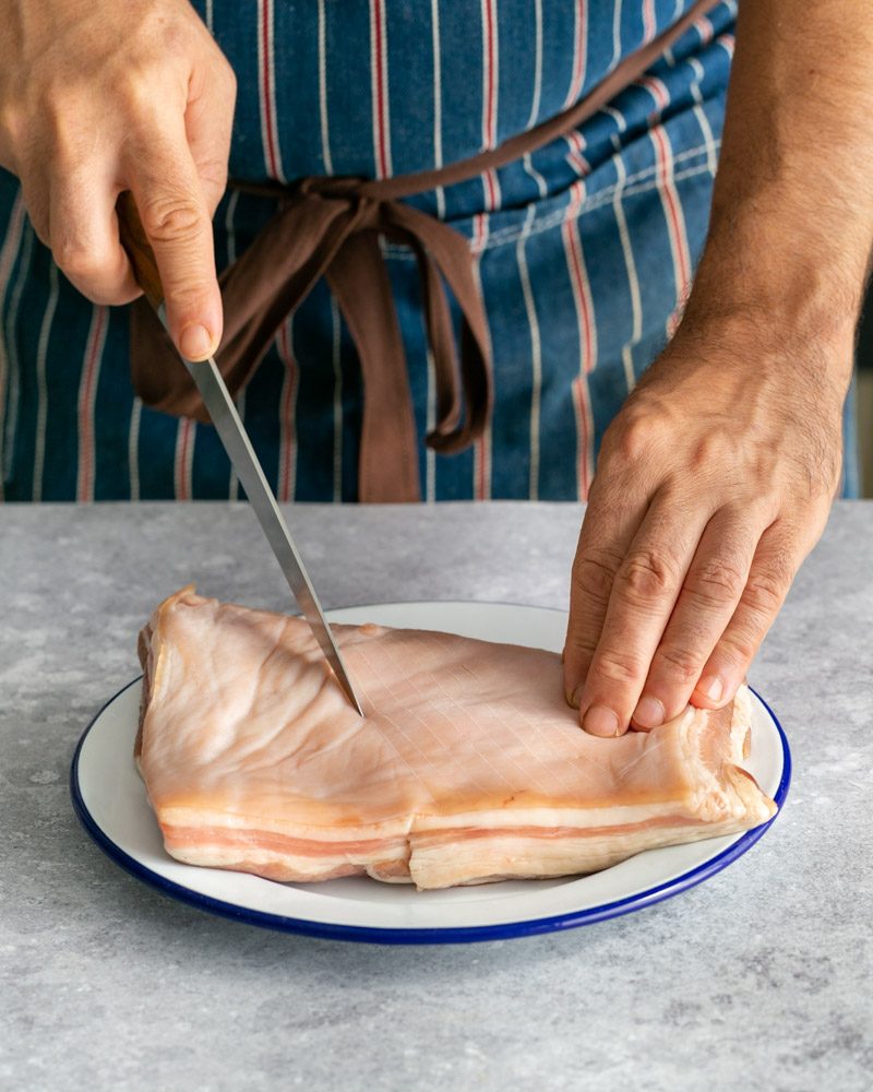 Scoring the pork belly