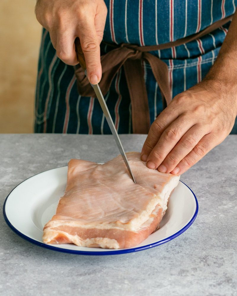 Scoring the pork belly