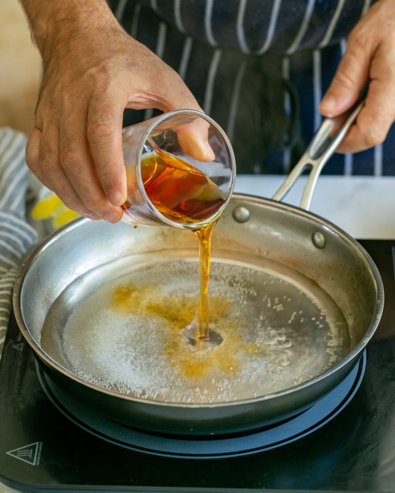 Preparing poaching liquid with amaretto for apricots