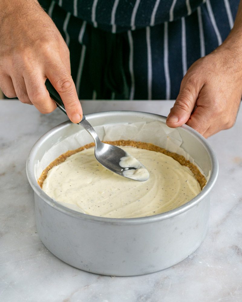 Spread cheesecake filling evenly using a spoon