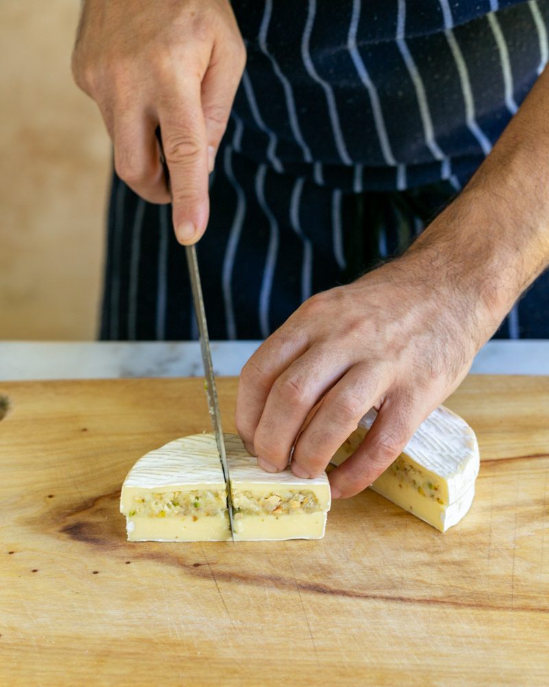 Cutting the stuffed brie into triangles