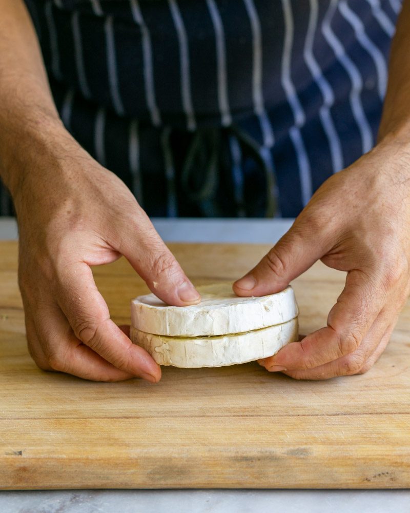 Brie cheese halves pressed back together