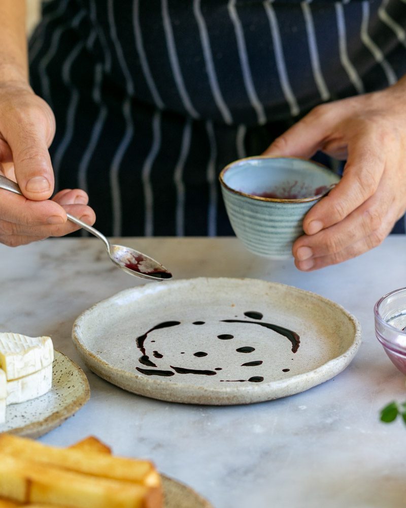 Drizzling wine reduction on plate