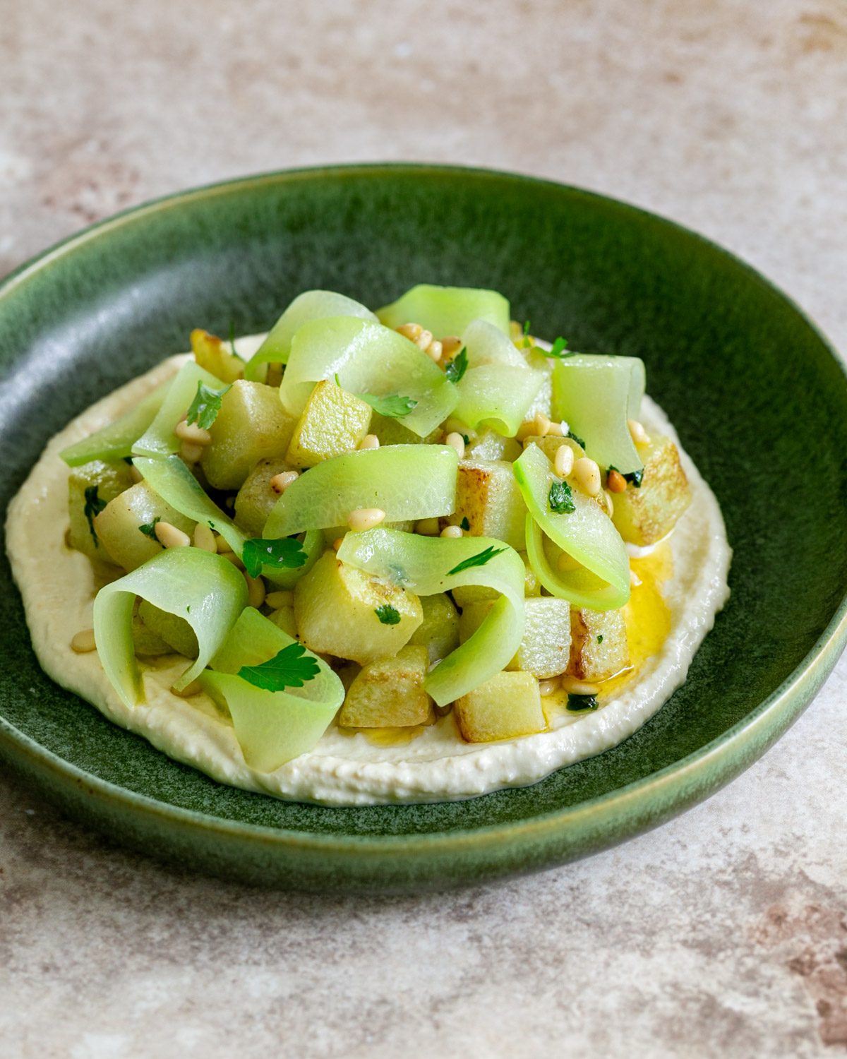 choko vegetable served with hummus and pine nuts