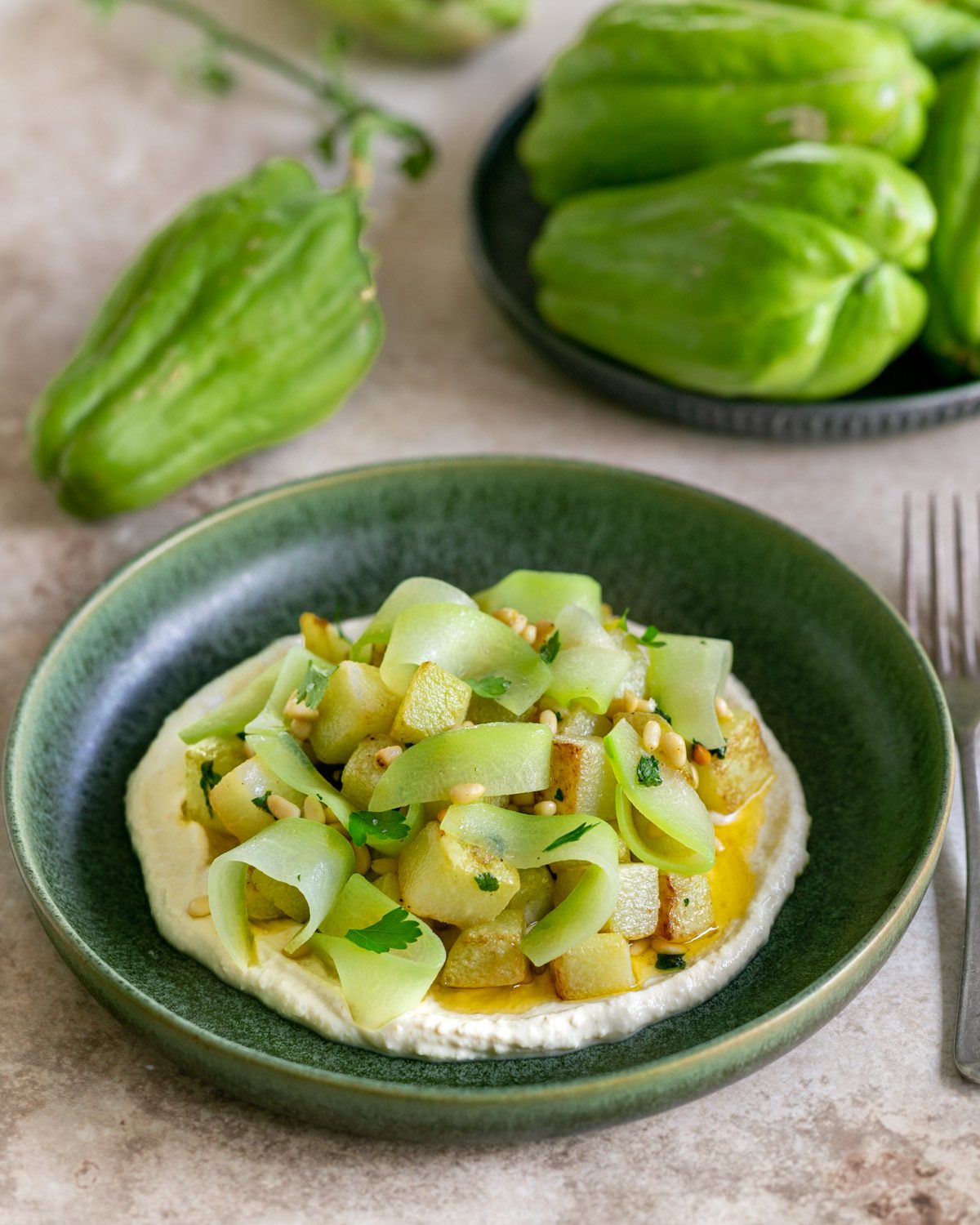 Choko vegetable roasted and served with pine nuts and hummus