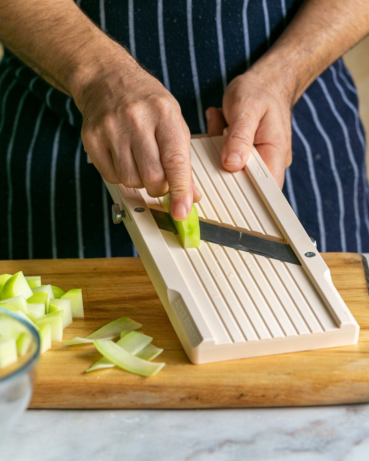 Slicing choko on a mandoline