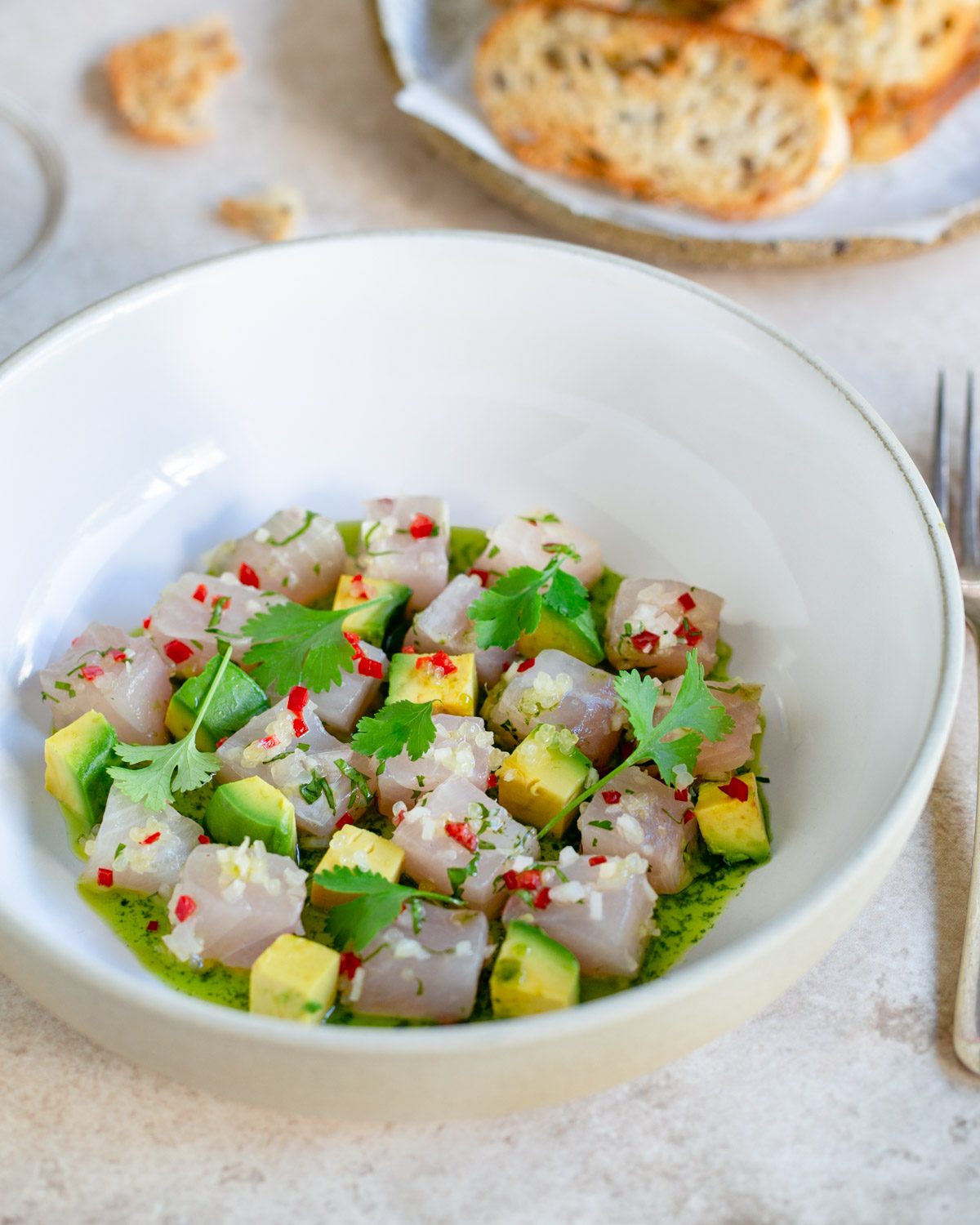 Hamachi crudo plated in a bowl 