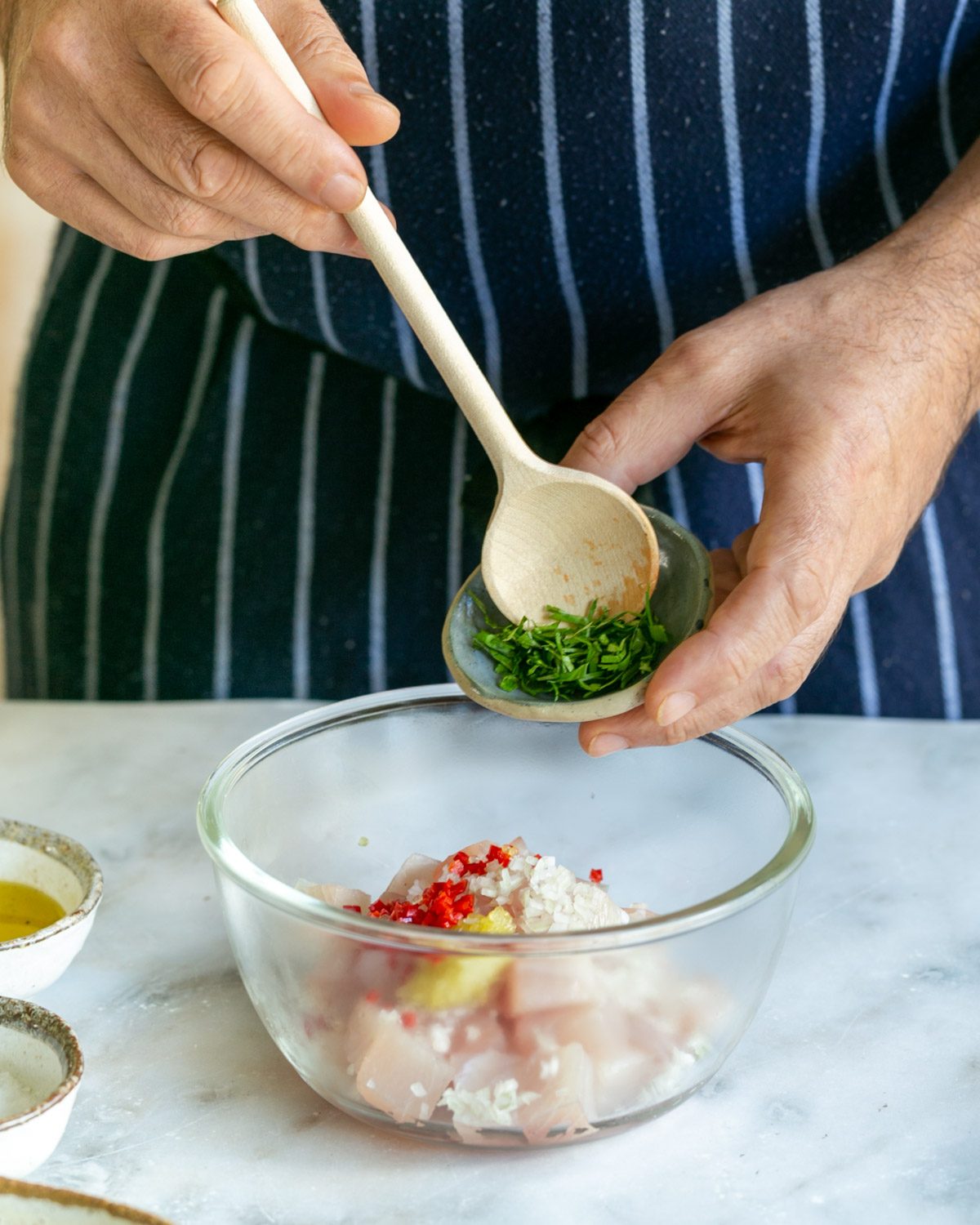 Mixing chopped ingredients to cut hamashi fish