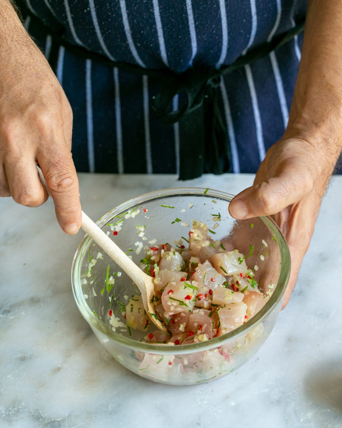 Mixing all crudo ingredients in a bowl