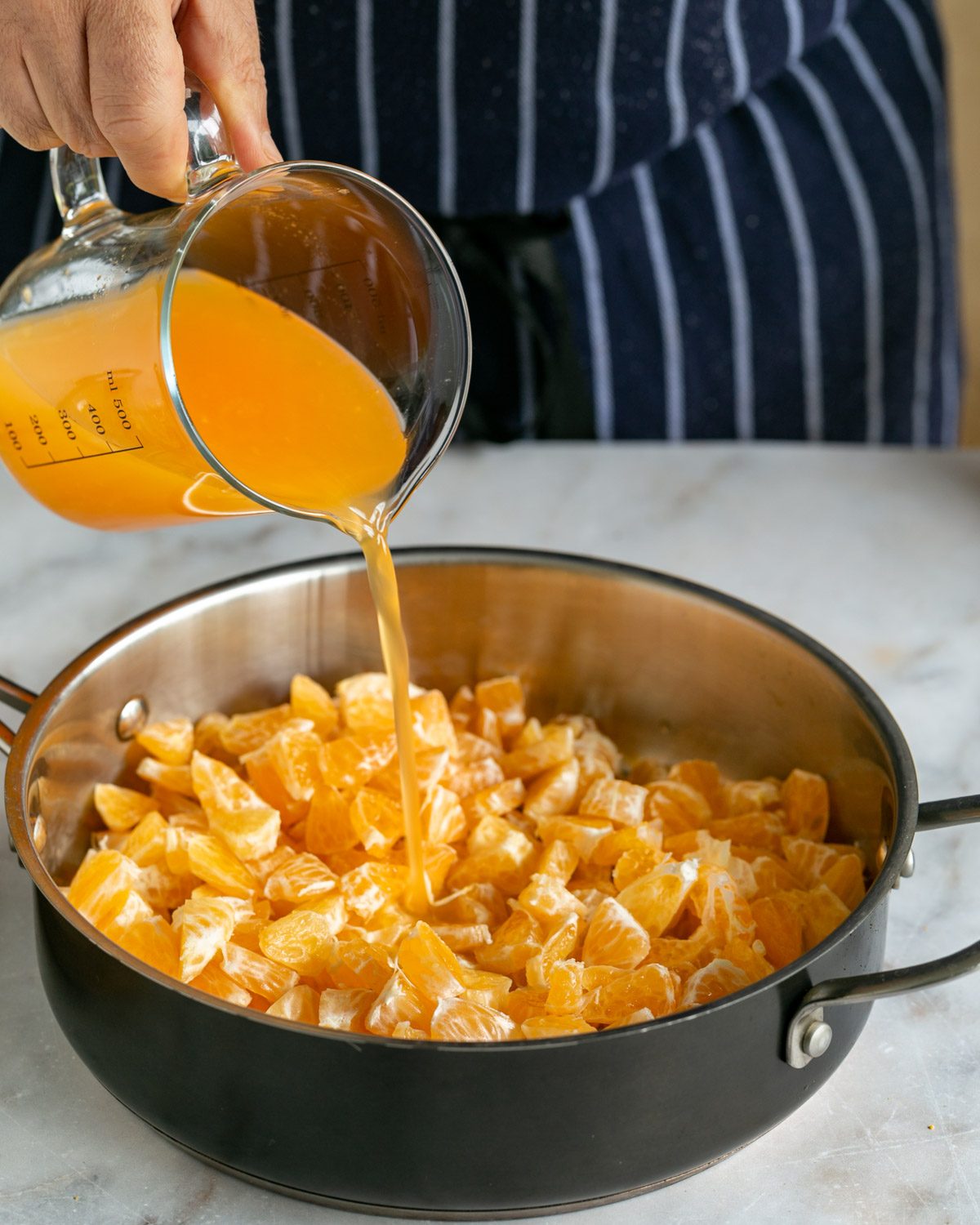 Adding mandarin and lemon juice to pot