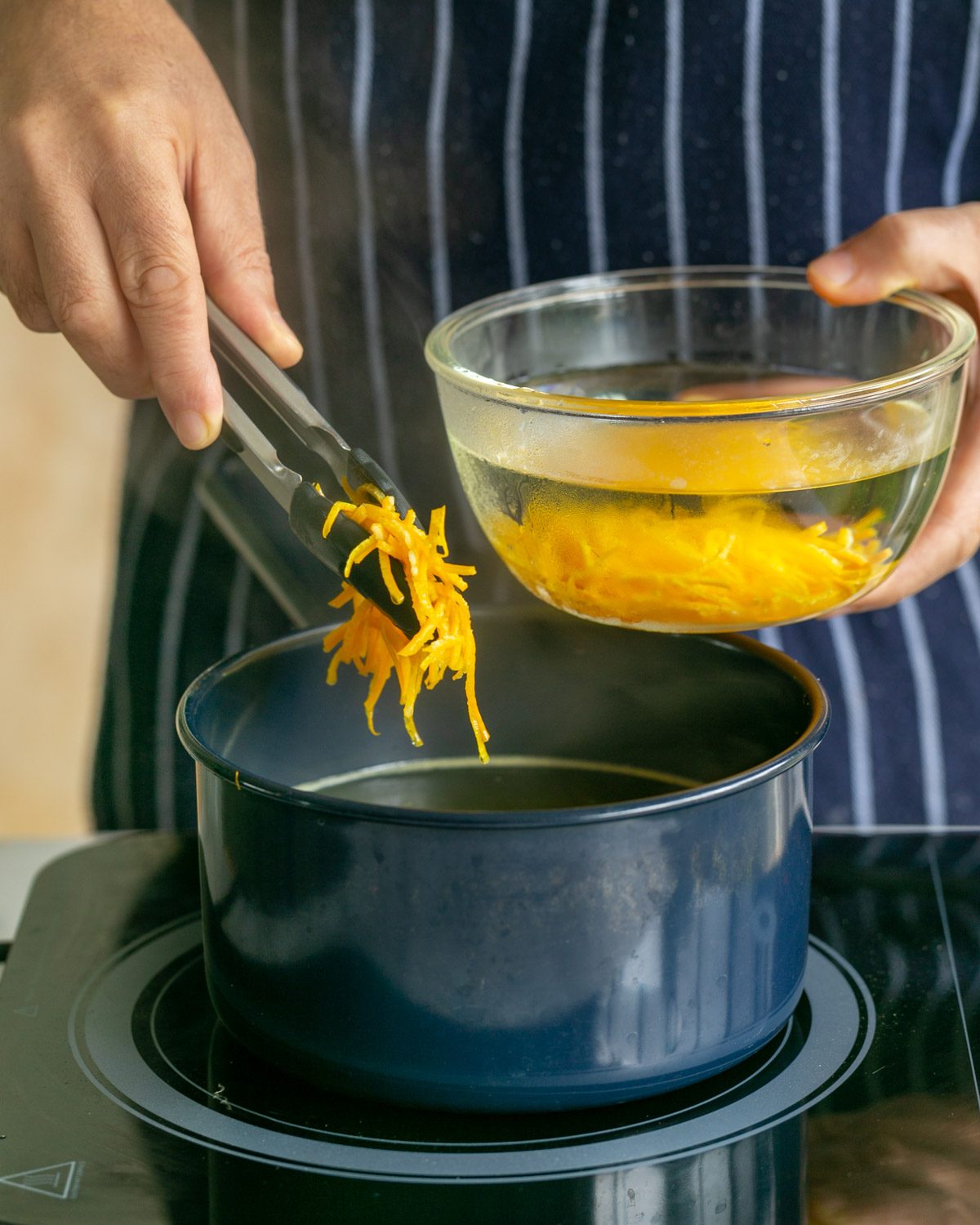 Taking out mandarin peel julienne's from boiling water