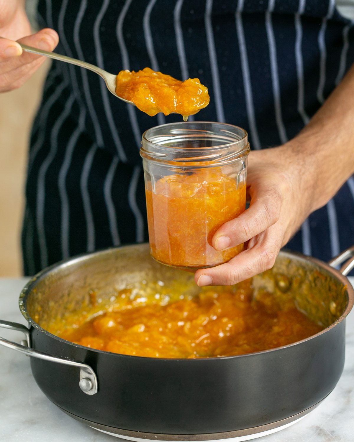 Cooked Mandarin marmalade transferred to jar