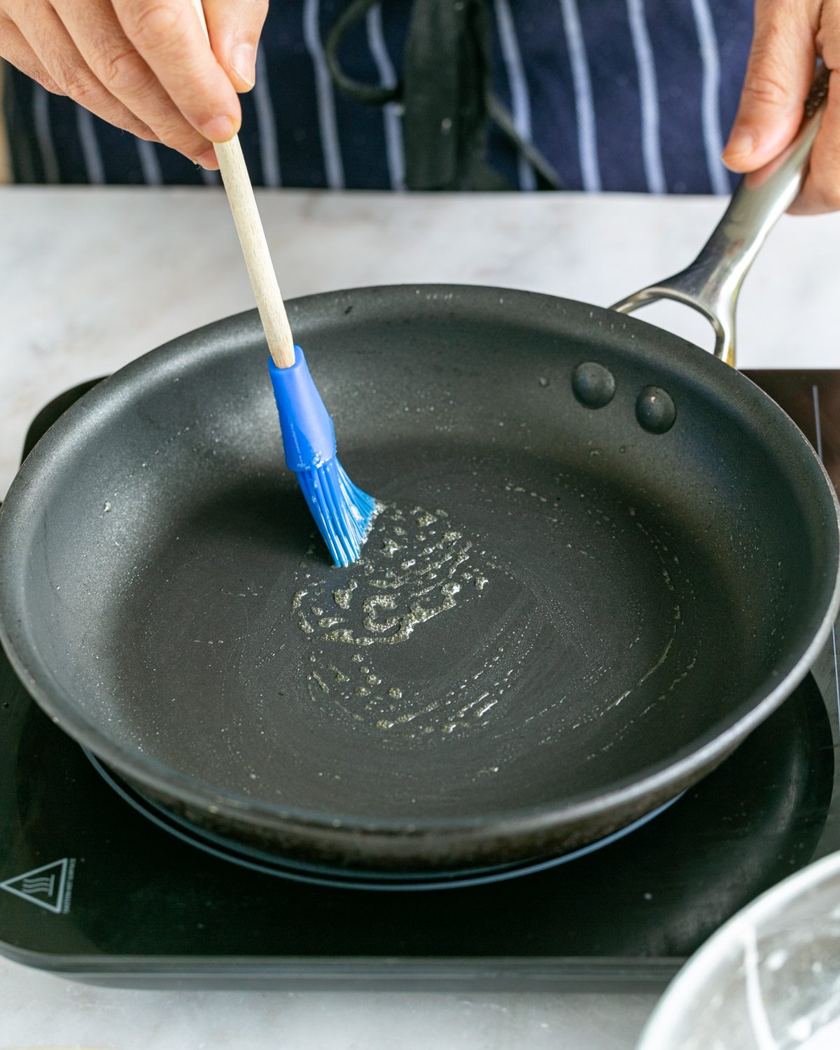 Melted butter in hot pan to make crepes