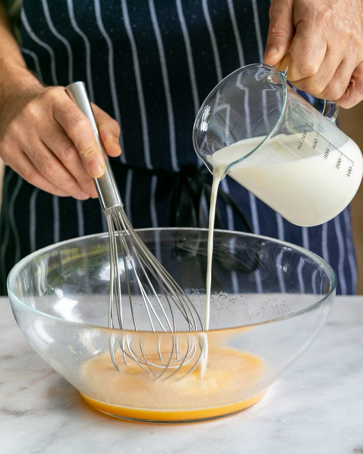 Adding milk to make crepe batter