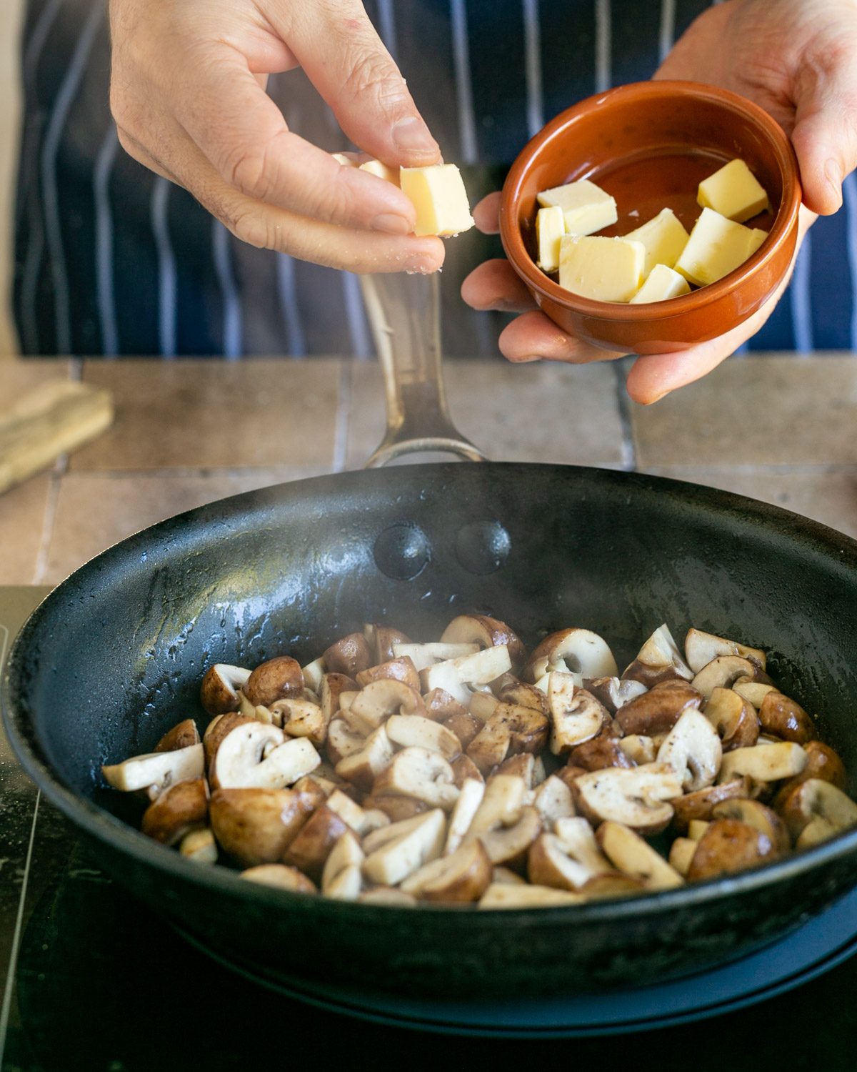 Adding butter to roast mushrooms