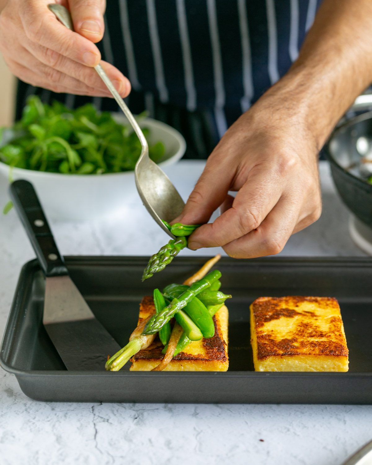 Plating up the polenta with vegetables