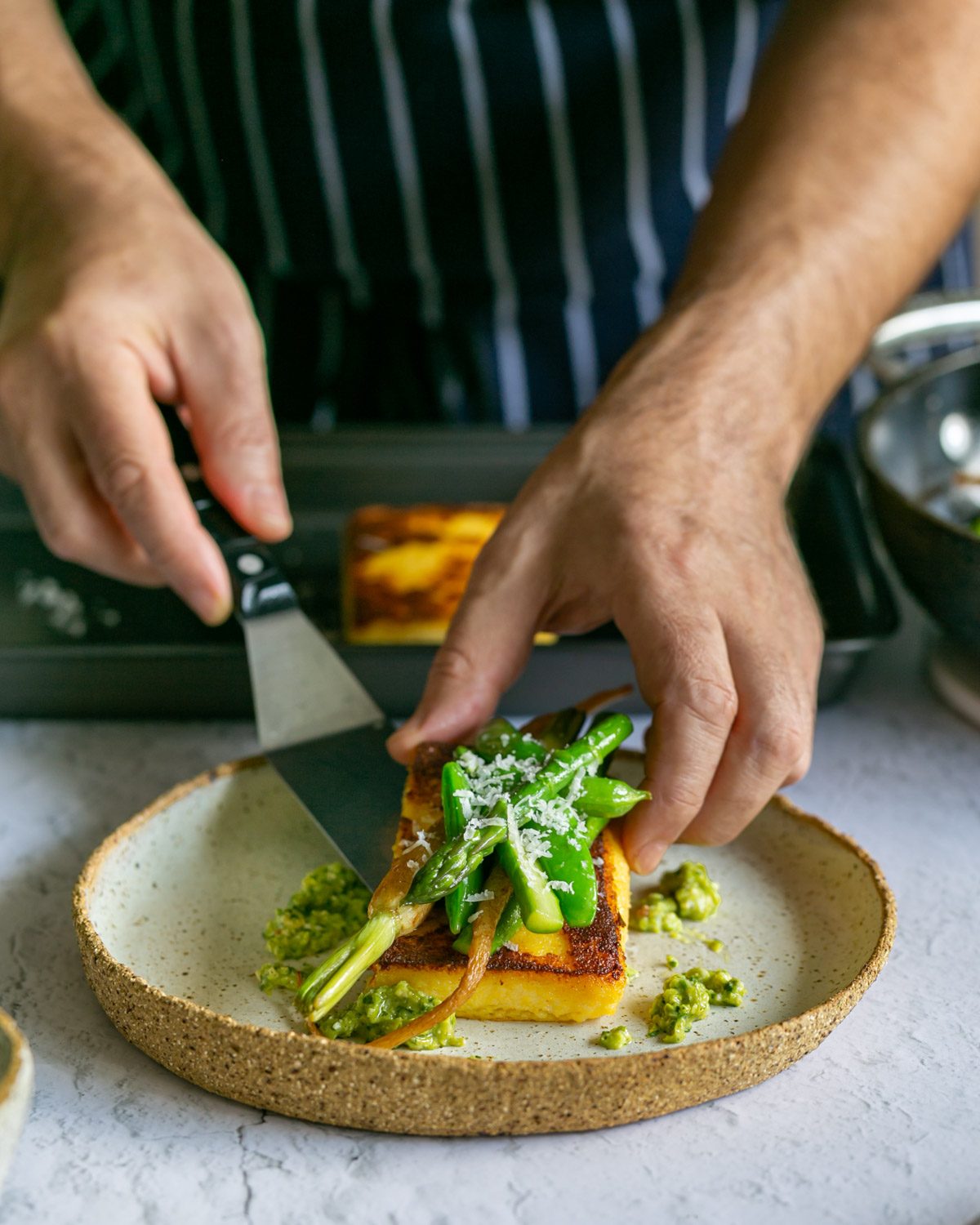 Plating up the polenta with vegetables