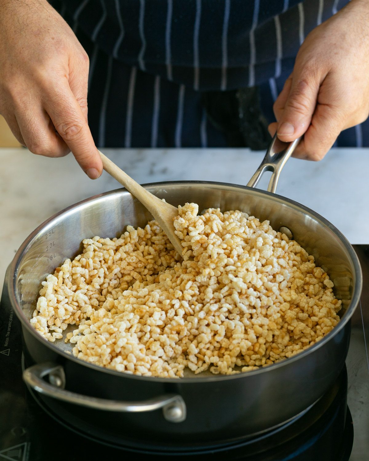 caramelizing puffed rice in a pan