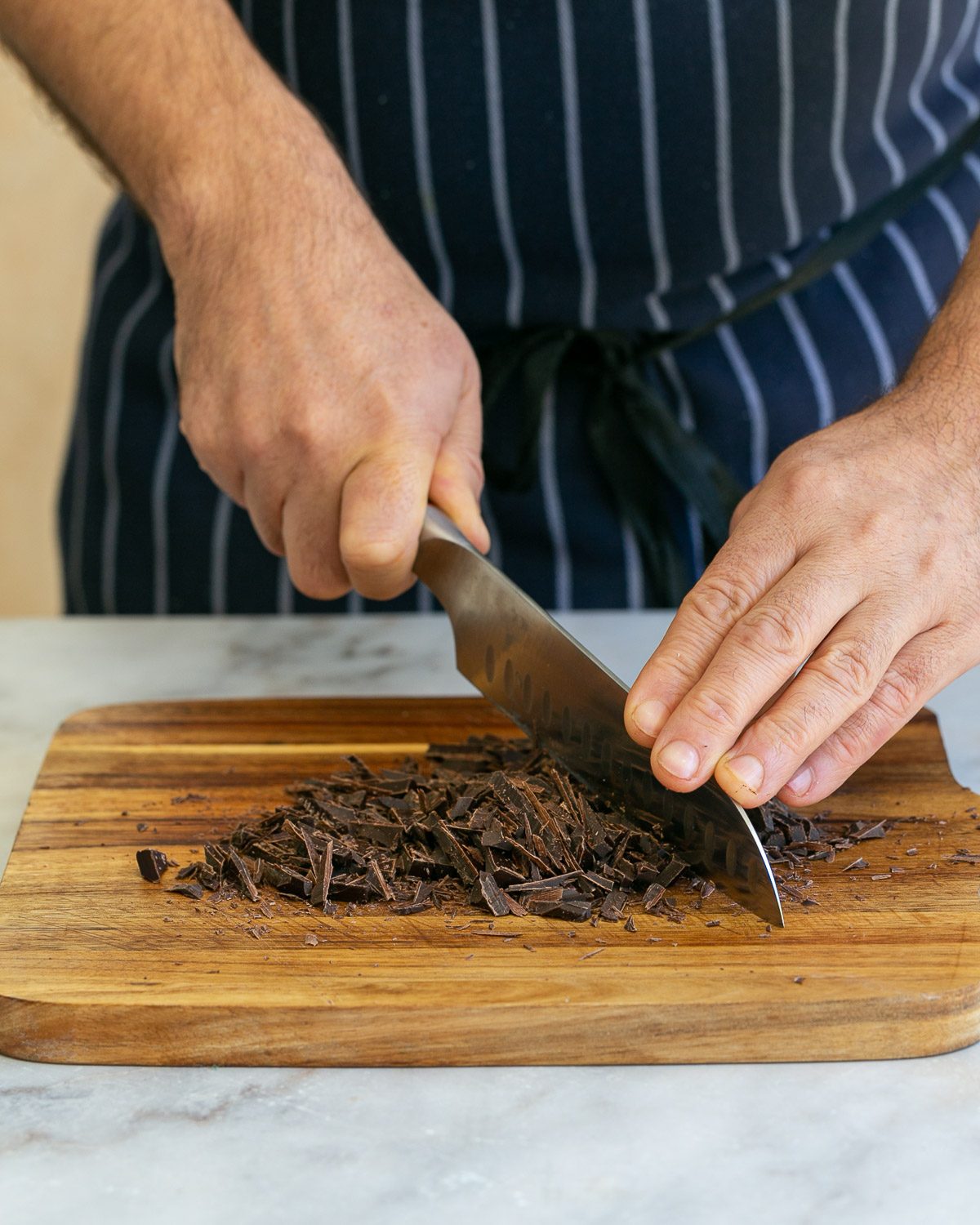 Chopping dark chocolate with a knife