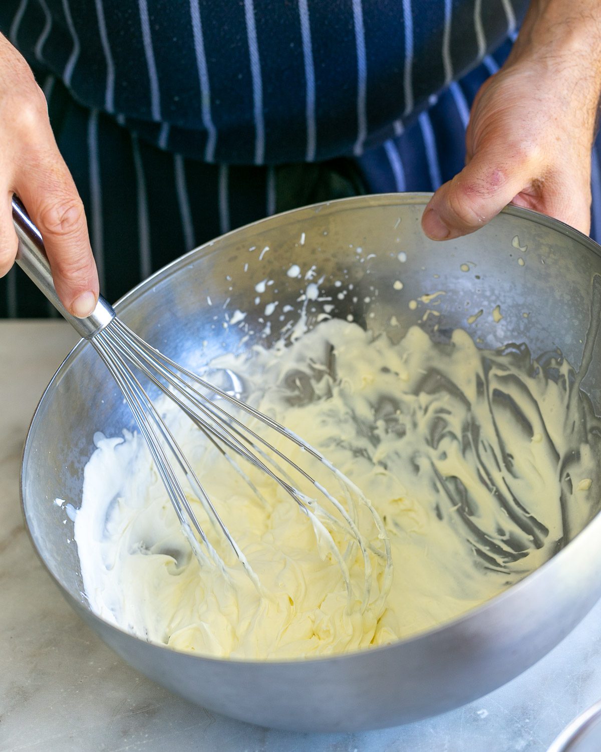 Whipping cream in a heat resistant bowl