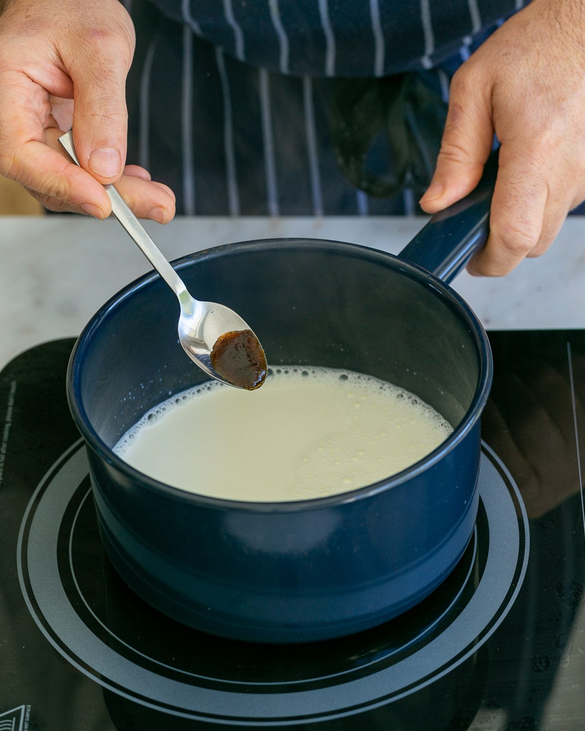 Adding vanilla to milk in a pot