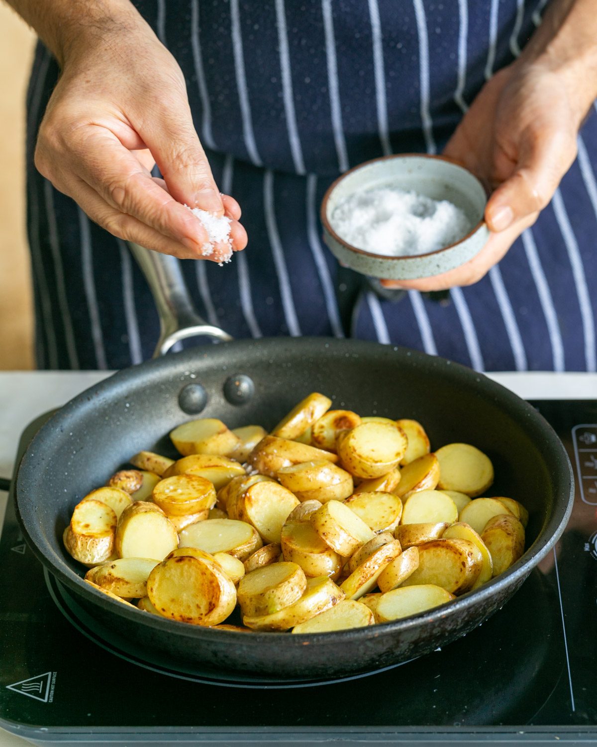 Adding salt while roasting kipfler potatoes