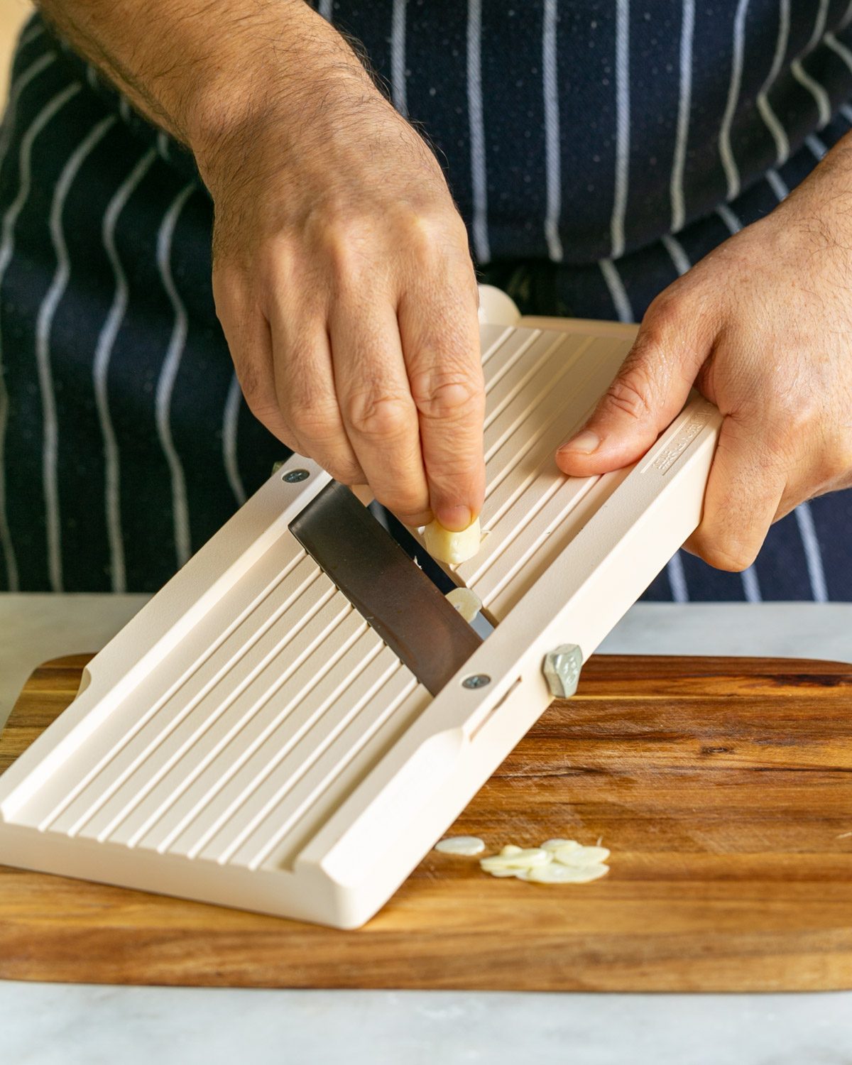 Slicing garlic on mandoline