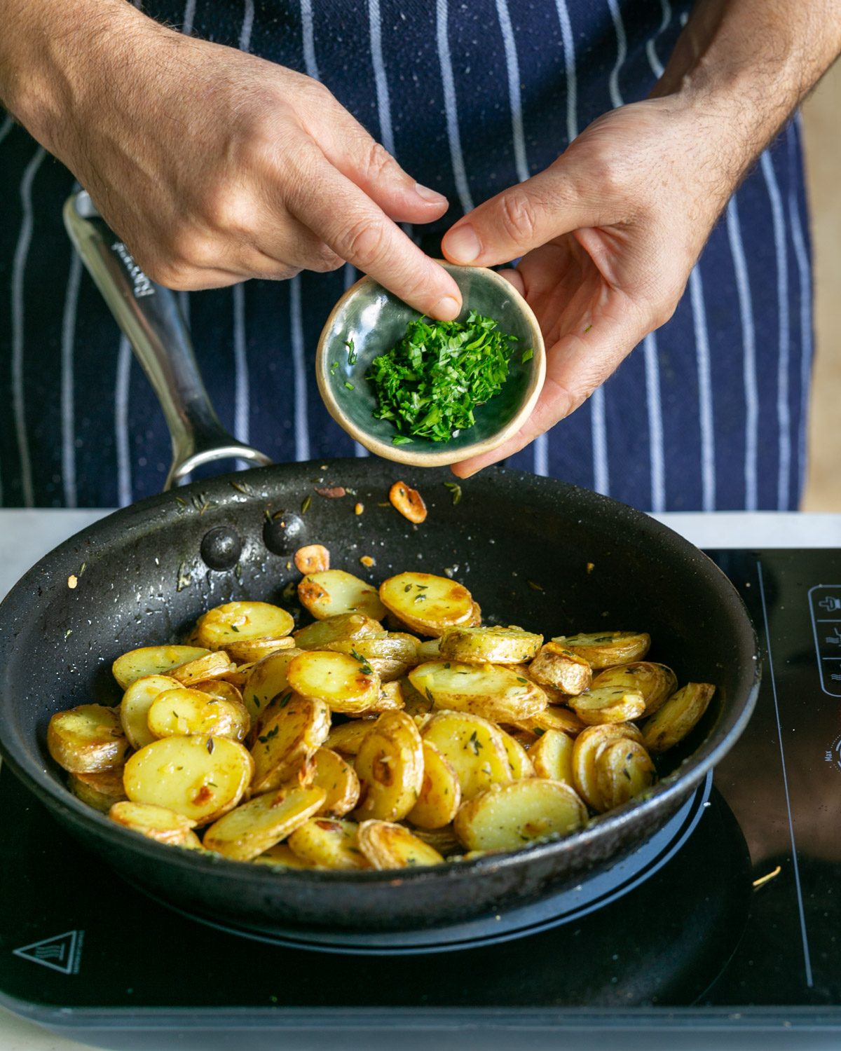 Chopped parsley added to cooked potatoes