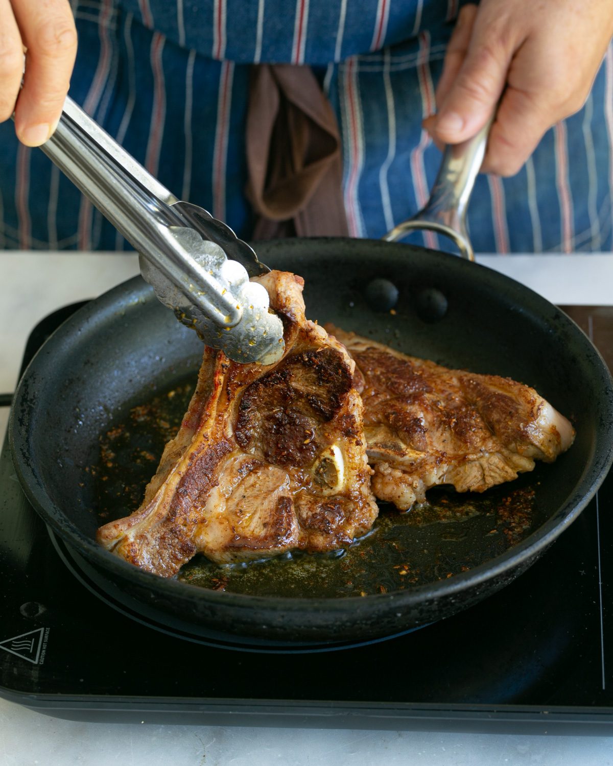 Cooking lamb chops in a pan