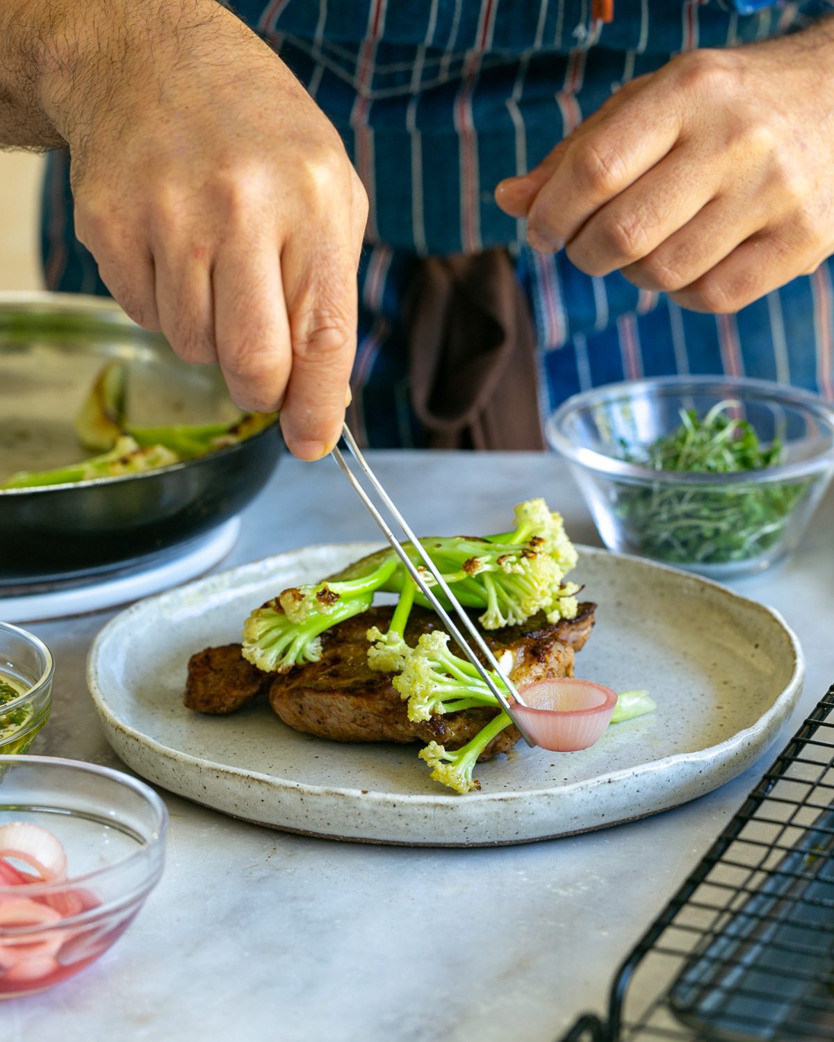 Plating up the lamb chops with garnishes