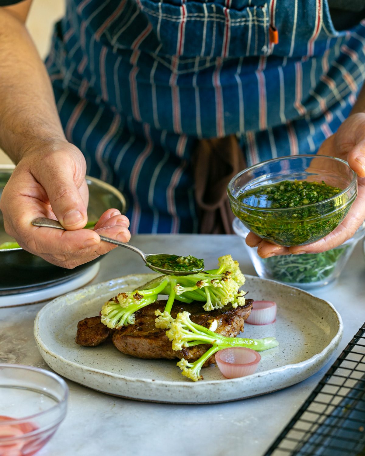 Plating up the lamb chops with the walnut gremolata