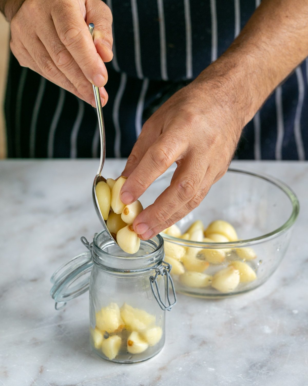 Adding blanched garlic to a jar