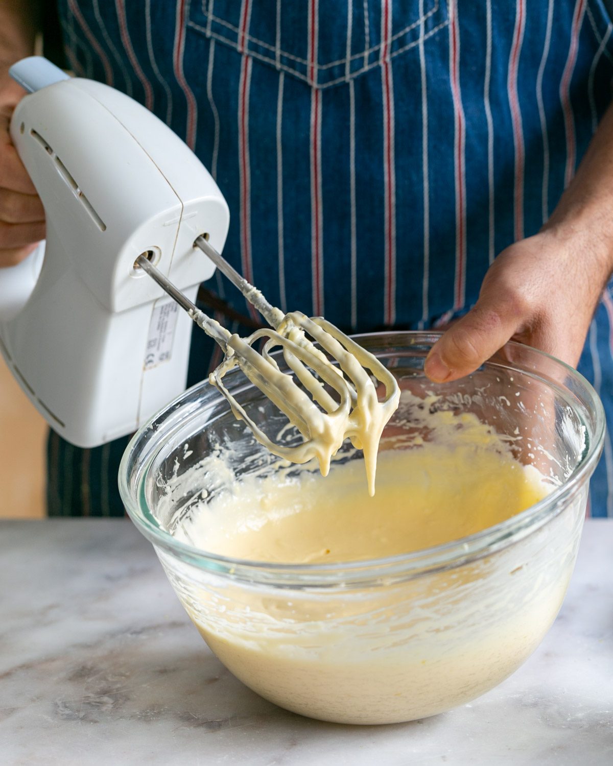 Mixing eggs in cheesecake batter