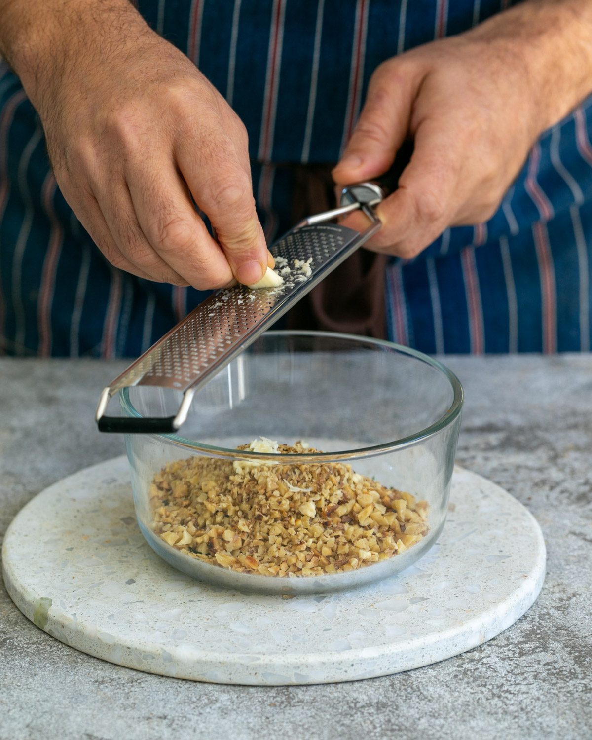 Grating garlic into gremolata