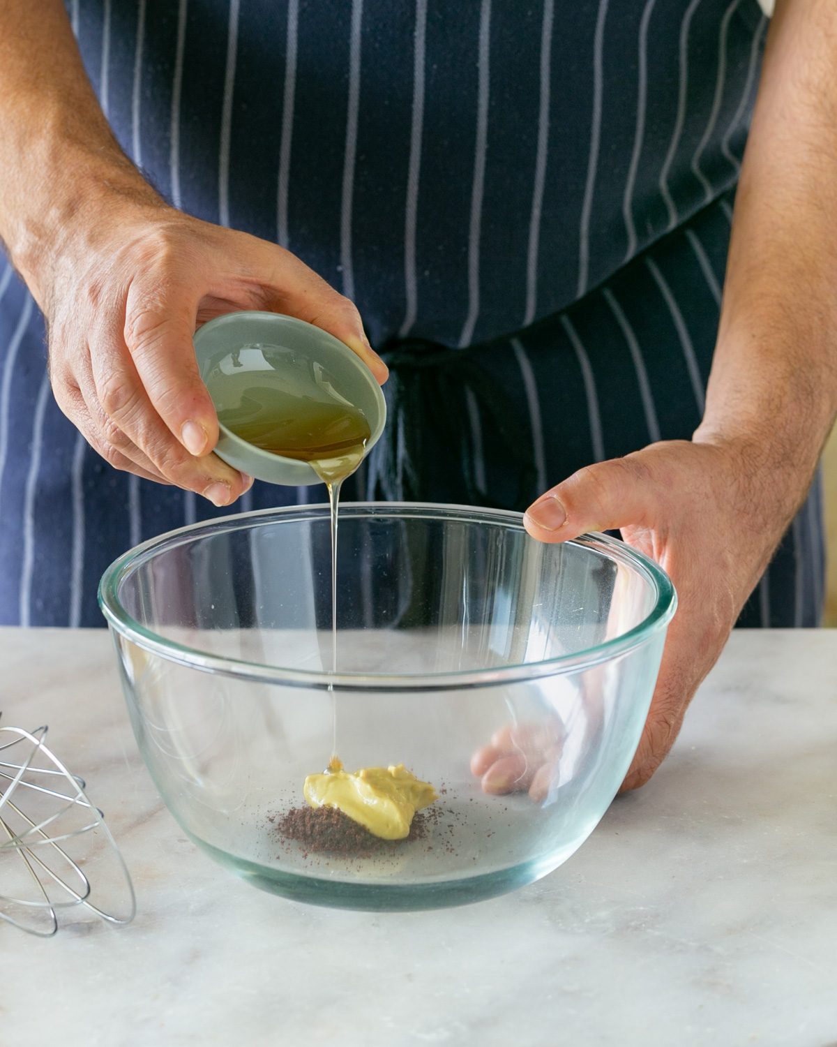 Making sumac dressing in a glass bowl