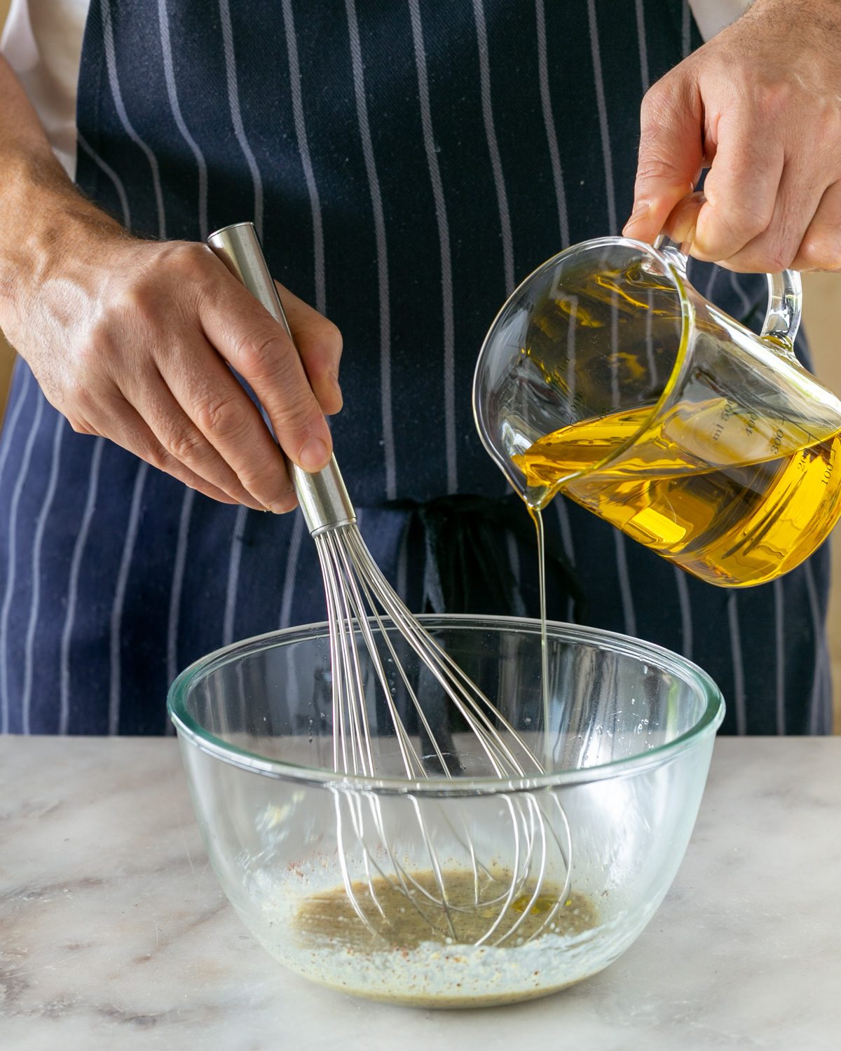 Adding olive oil to sumac dressing