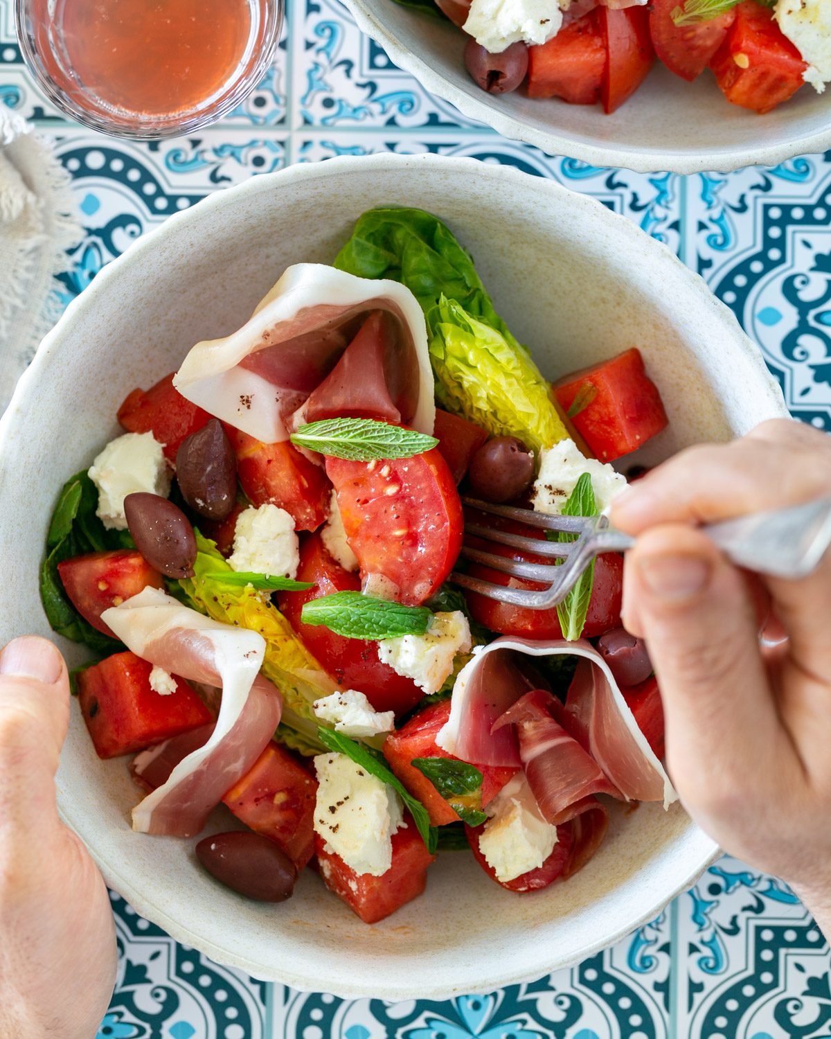 Eating Tomato Watermelon Salad with a fork