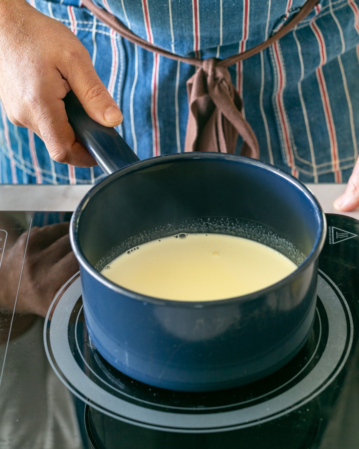 Heating cream to add to melted sugar