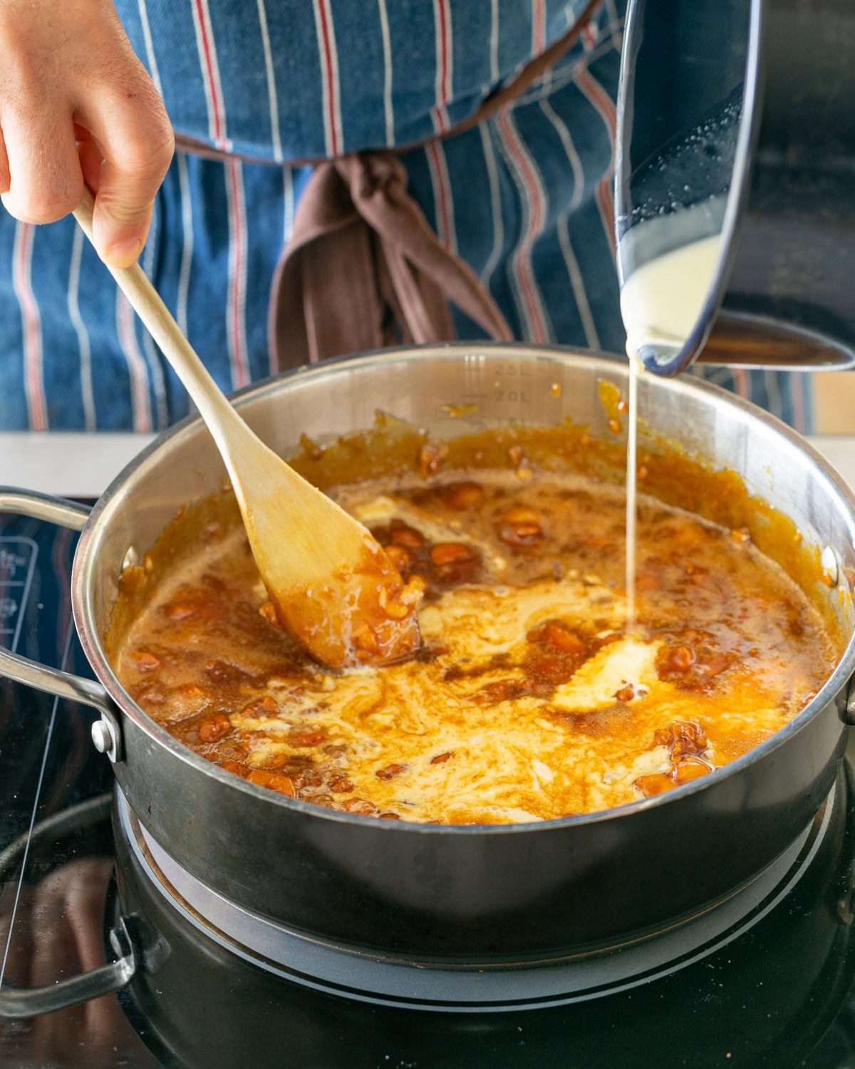 Adding cream to the macadamia caramel