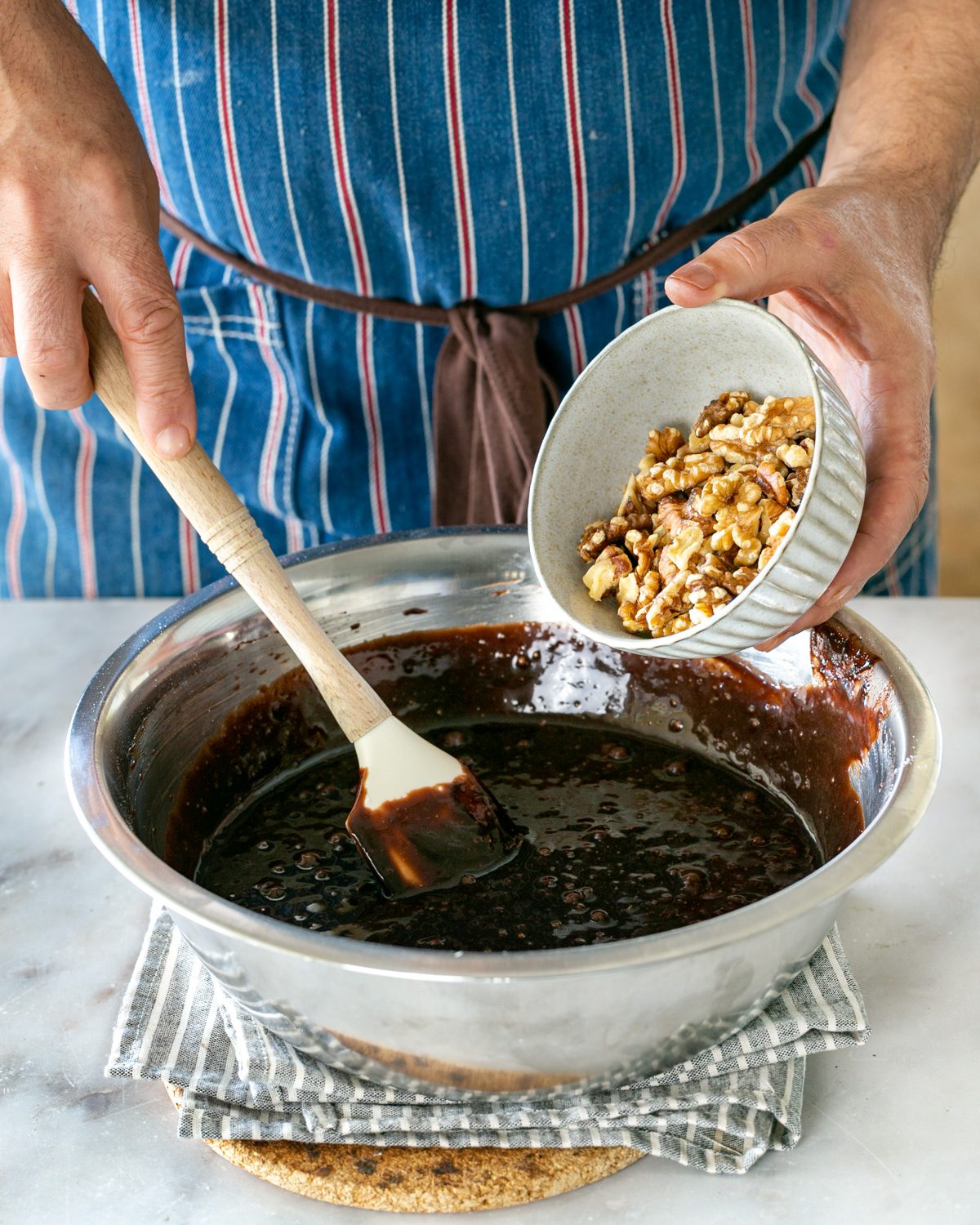 Flour and walnuts added to brownie batter