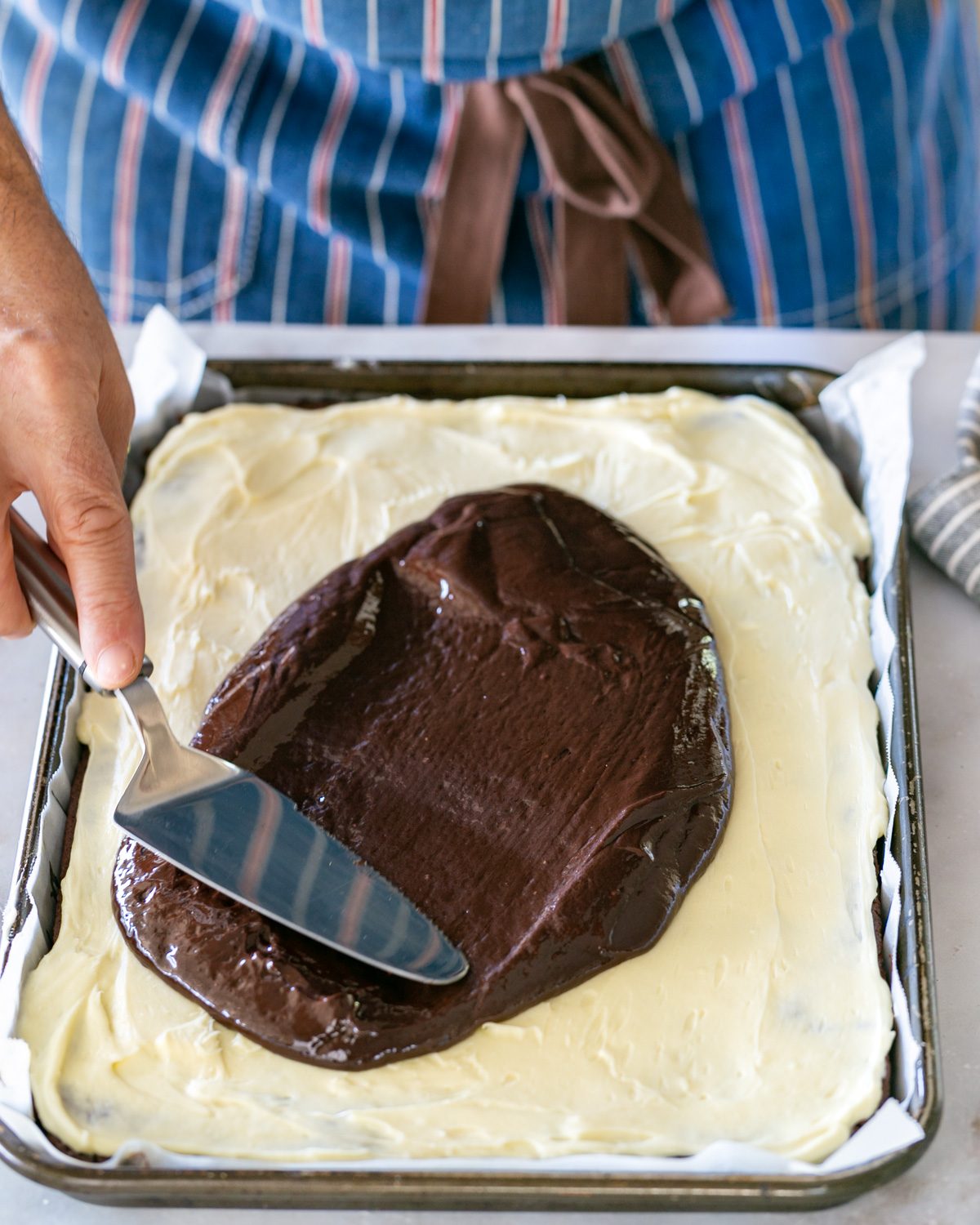 Chocolate glaze spread over cream cheese layer