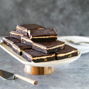 Coffee walnut brownie slices on a cake stand